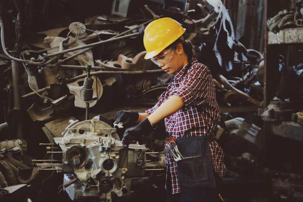 A person using a mechanical device working on equipment